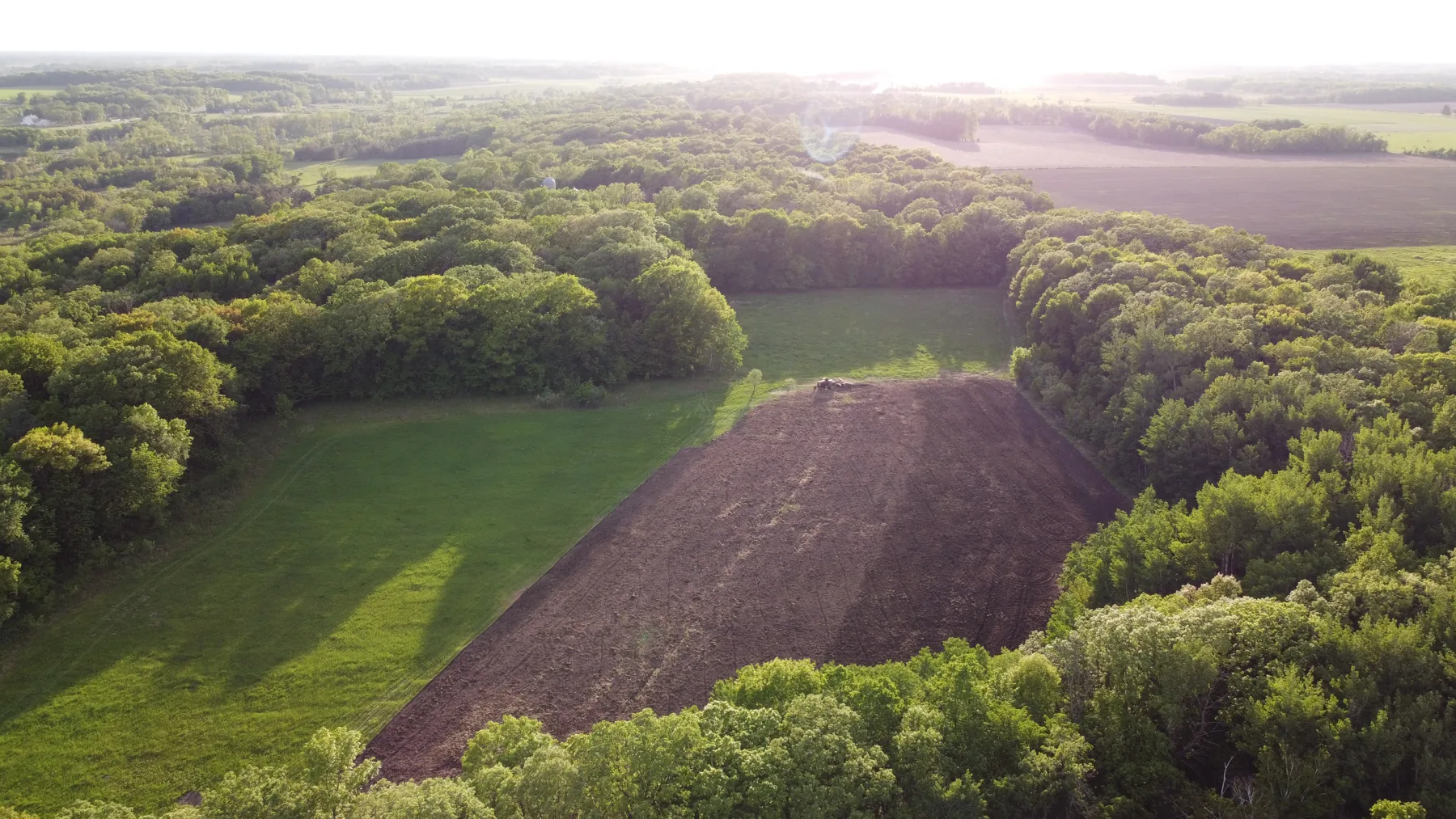 Aerial view of the fields and pasture at golden hour