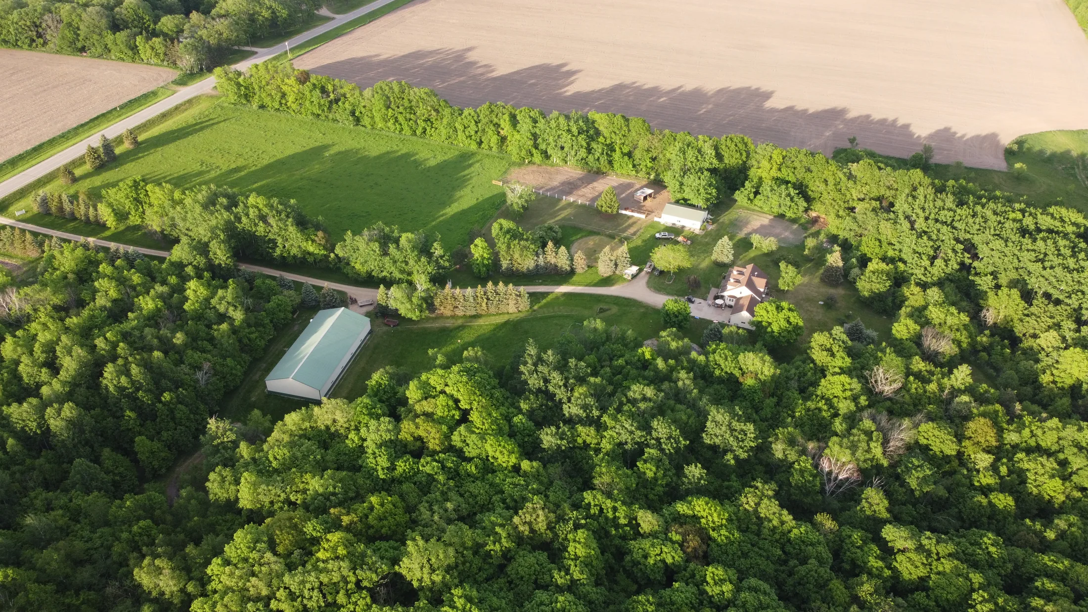 Aerial view of the Picray farmstead surrounded by fields and trees