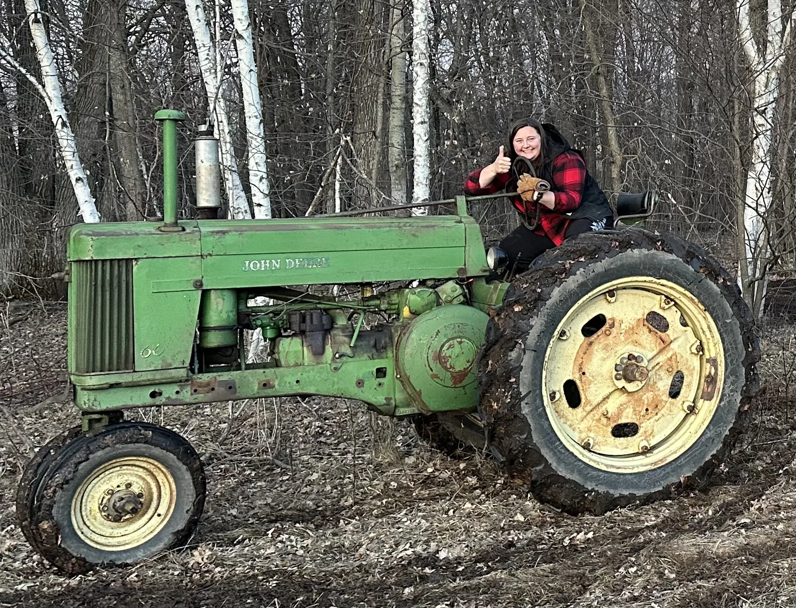 Sophie sitting on the 1953 John Deere 60 tractor